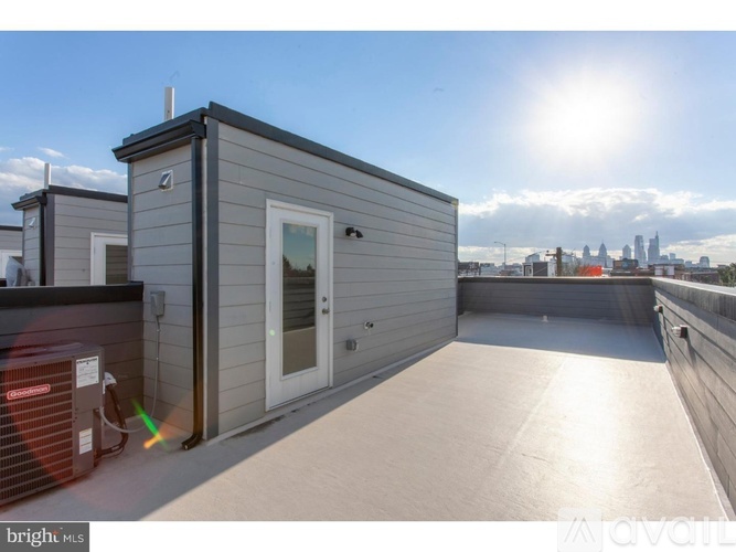 A sunny day at the rooftop of a building with a view of the city skyline.