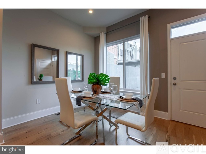 A dining room with a glass table and chairs.