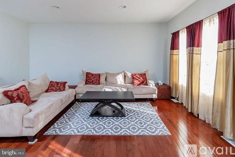 A living room with a white couch and a coffee table.
