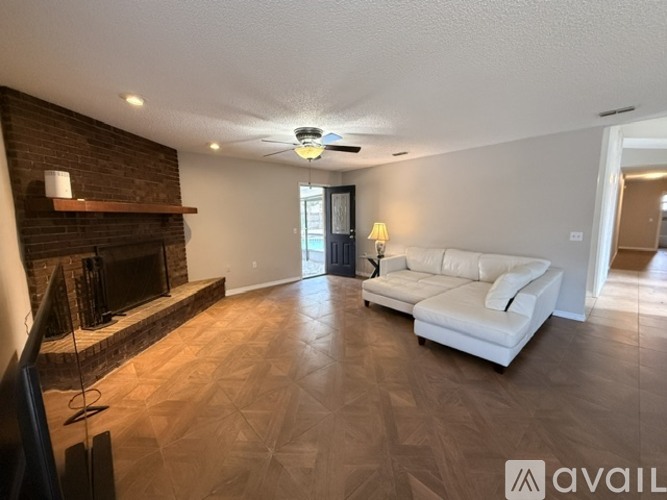 A living room with a fireplace and a white couch.