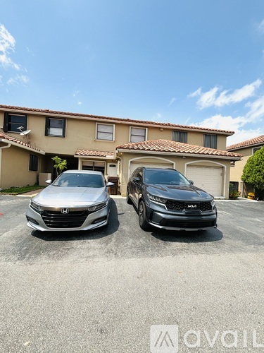 Two cars parked in front of a house with the logo "Avail" on the bottom right.