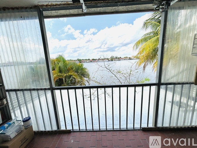 A balcony with a view of a body of water and trees.