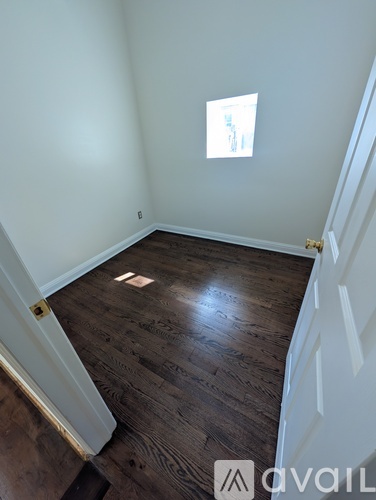 A room with wooden floors and a white door.