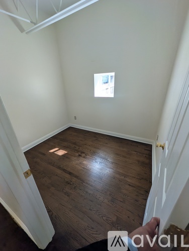 A room with wooden floors and white walls.