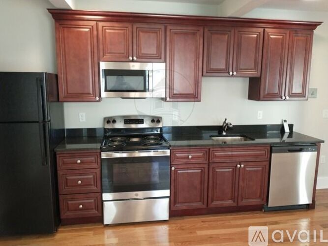 A kitchen with wooden cabinets and stainless steel appliances.