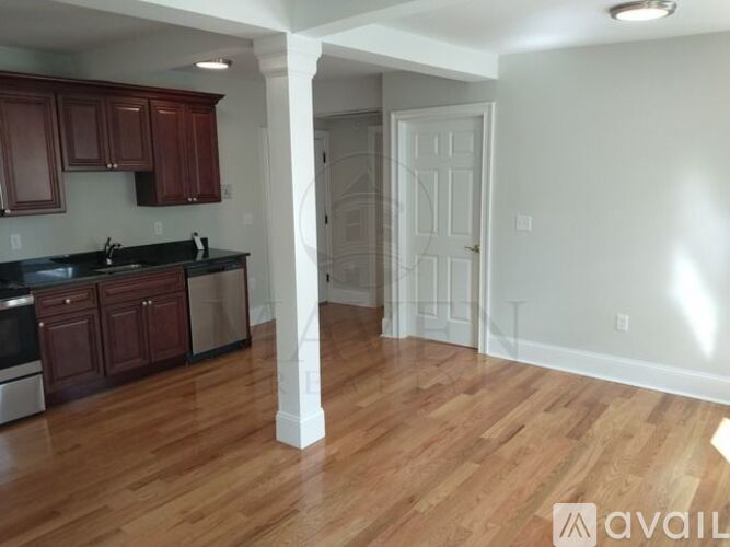 A kitchen with wooden cabinets and a white door.