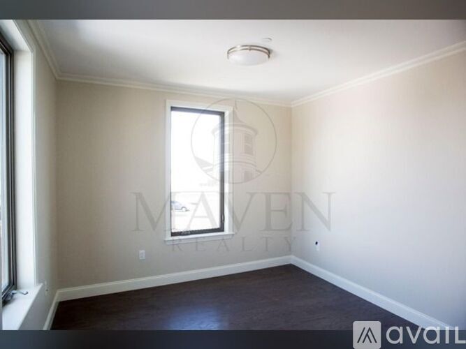 A room with a window and a ceiling light.