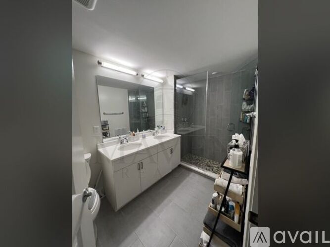 A bathroom with a sink, mirror, and toilet.