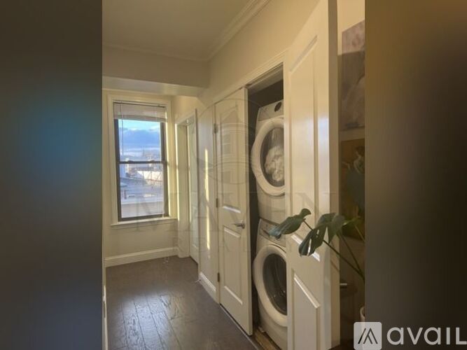 A laundry room with a washer and dryer stacked on top of each other.