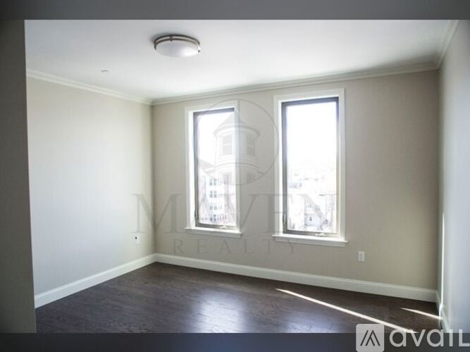 A room with a window and a ceiling light.