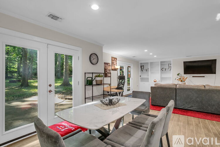 A modern dining room with a glass table and chairs.