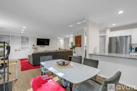 A modern kitchen with a dining table set for four.