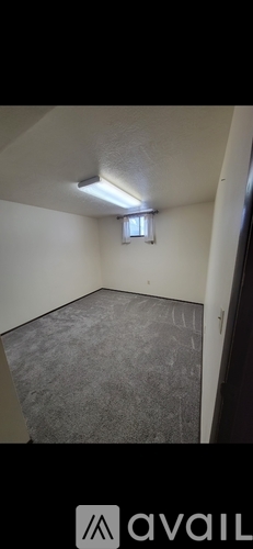 A room with a carpet floor and a window.