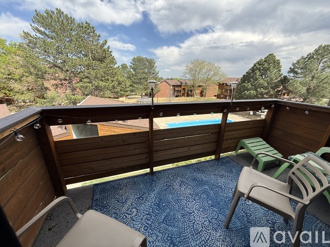 A balcony with a pool table and chairs.