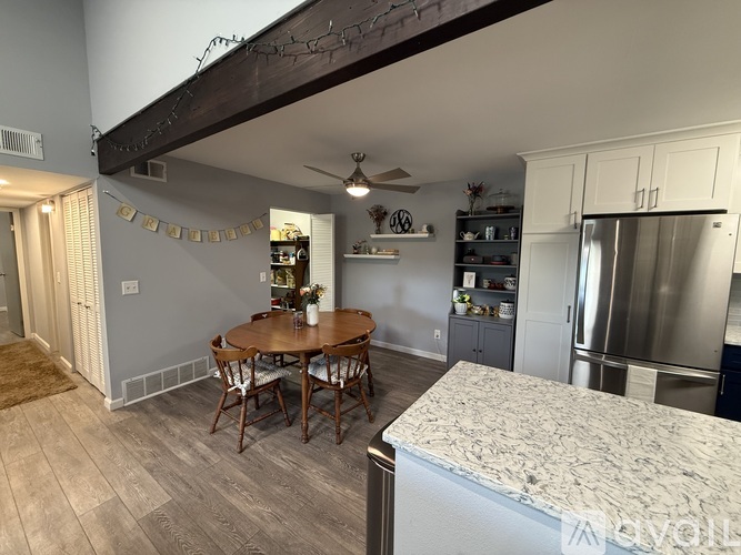 A kitchen with a table and chairs in the middle of the room.