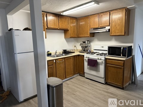 A kitchen with wooden cabinets and white appliances.