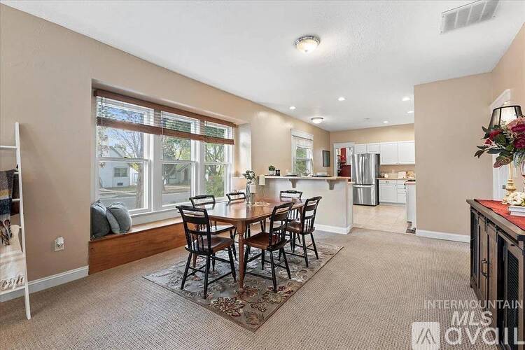 A dining room with a table set for six.