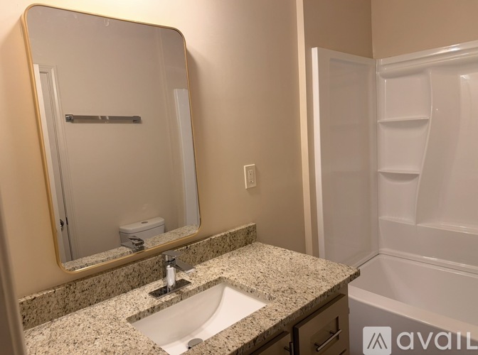 A bathroom with a granite countertop and a sink.