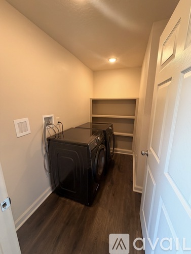A room with a washing machine and dryer in it.
