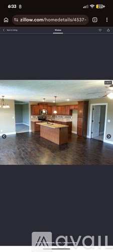 A modern kitchen with wooden cabinets and a central island.