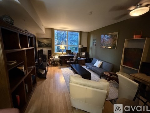 A living room with a white couch and a television.