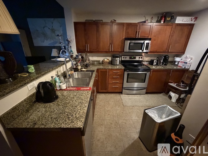 A kitchen with granite countertops and wooden cabinets.
