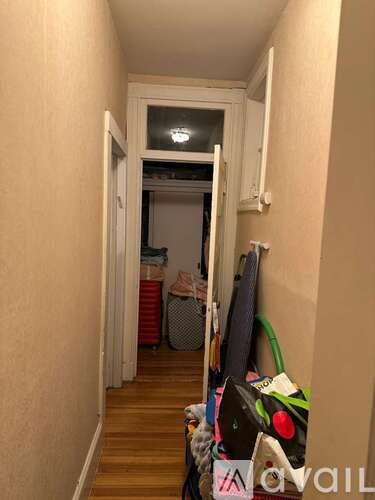A hallway with a doorway leading to another room.