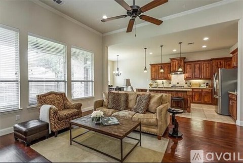 A living room with a leopard print chair and a glass coffee table.