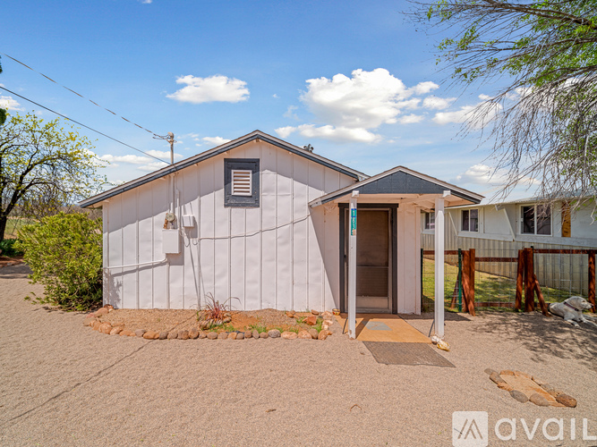 A house with a grey exterior is for sale.