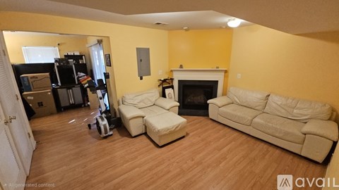 A living room with a white couch and a fireplace.