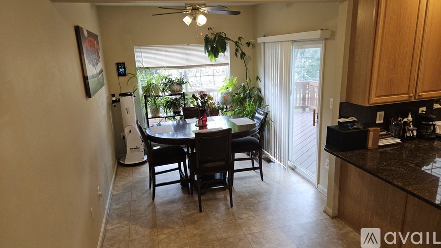 A kitchen with a dining table and chairs is available for rent.