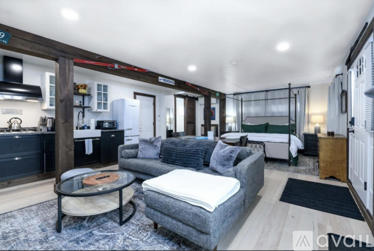 A living room with a grey couch and a coffee table.