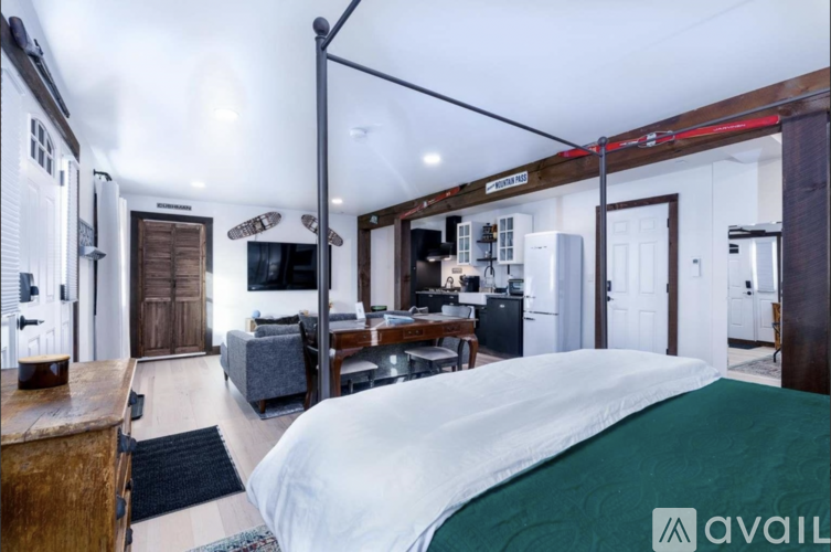A bedroom with a bed, desk, and chair is shown.