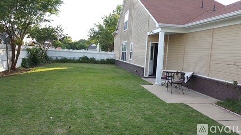 A house with a patio and a white fence.