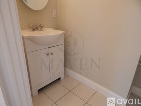 A bathroom with a sink and a mirror.