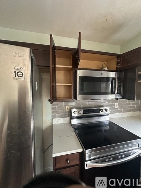 A kitchen with a stainless steel refrigerator and an oven.