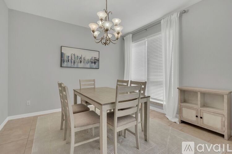 A dining room with a wooden table and chairs.