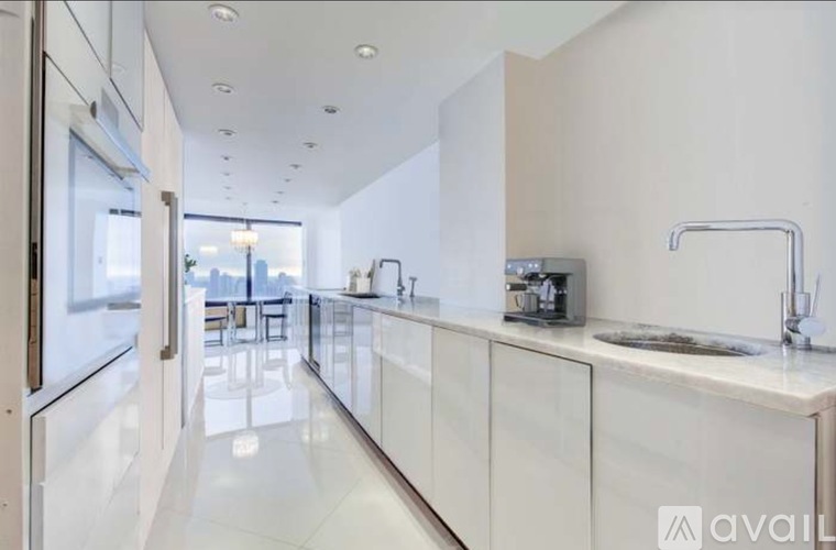 A modern kitchen with white cabinets and a sleek design.