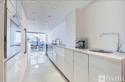A modern kitchen with white cabinets and a sleek design.