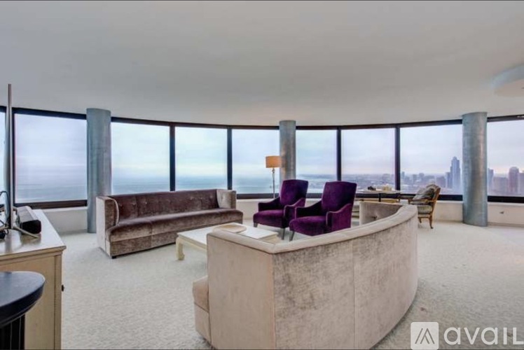 A living room with a large window overlooking the city.