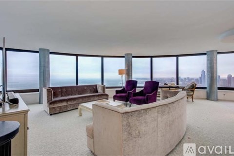 A living room with a large window overlooking the city.