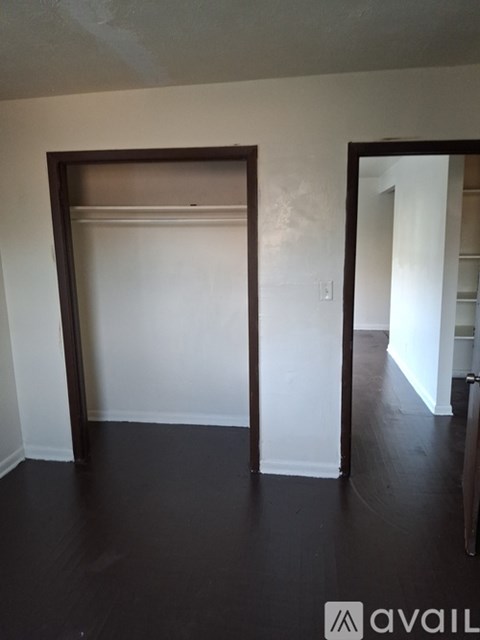 A room with a white wall and a black floor.