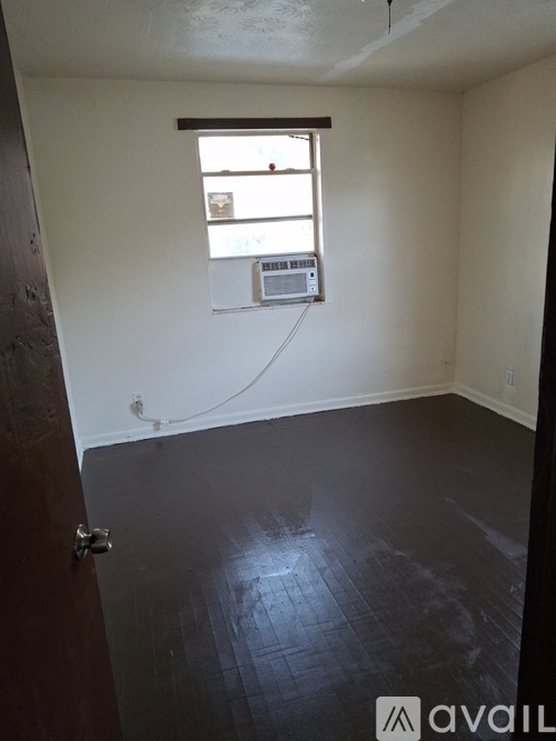 A room with a window and a tiled floor.