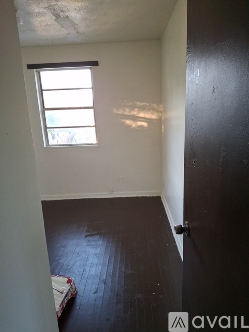 A room with a window and a door.