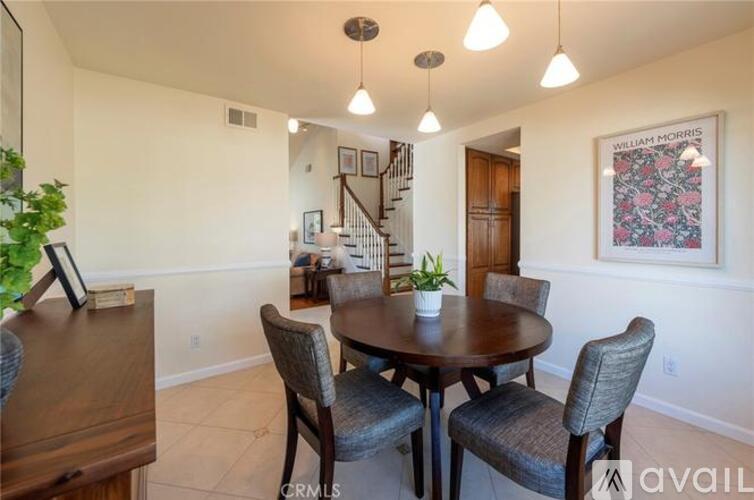 A dining room with a round table and chairs.