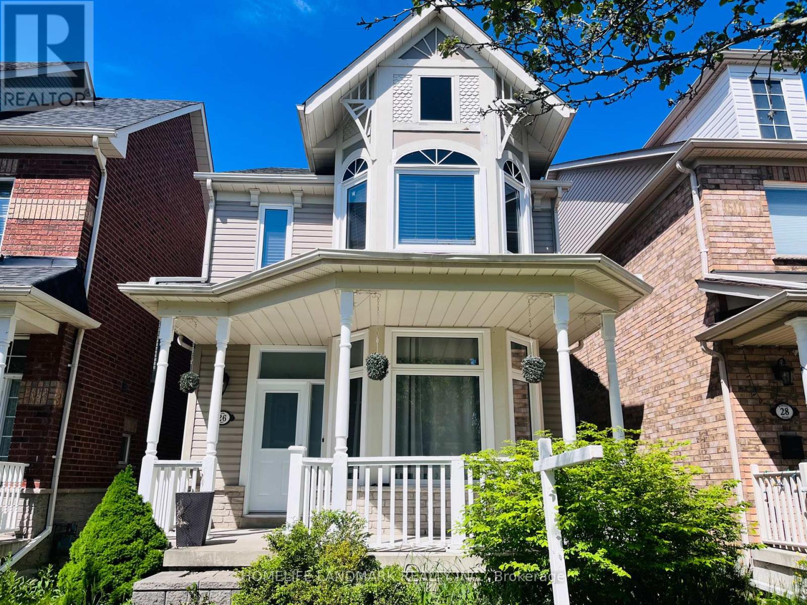 A house with a white porch and a brick facade.