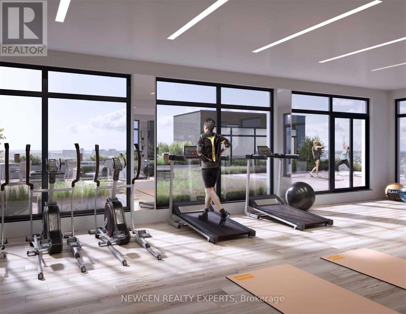 A gym with a variety of equipment including treadmills, weights, and exercise balls.