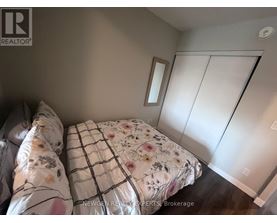 A bedroom with a bed and a mirror on the wall.