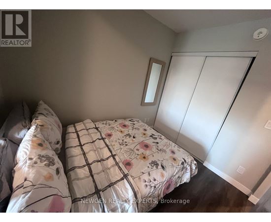 A bedroom with a bed and a mirror on the wall.