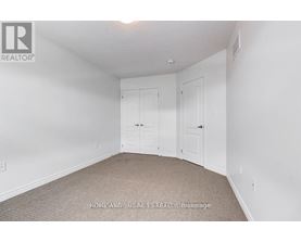 A bedroom with two doors and a carpeted floor.
